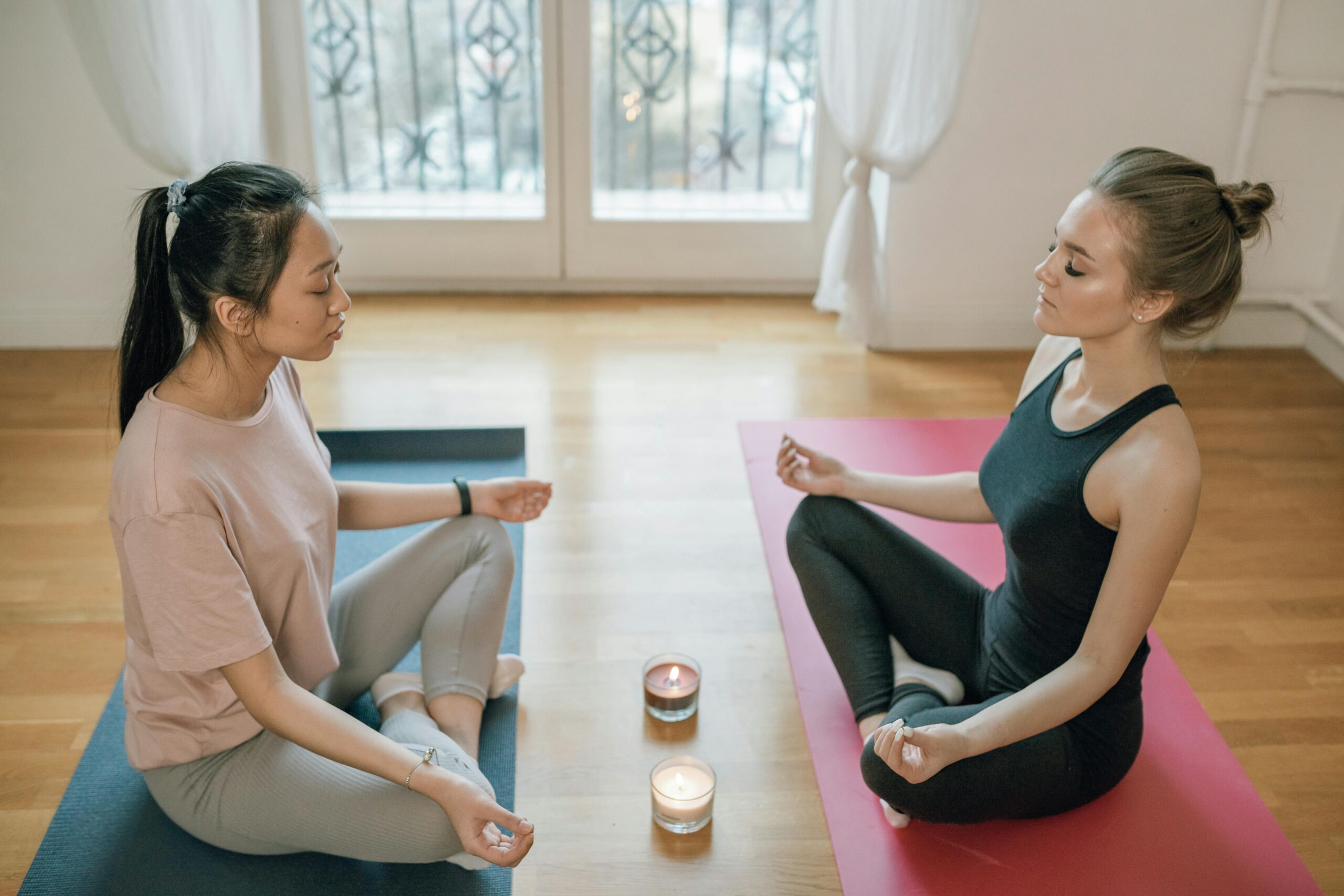 Group of women meditating together in a peaceful indoor yoga session