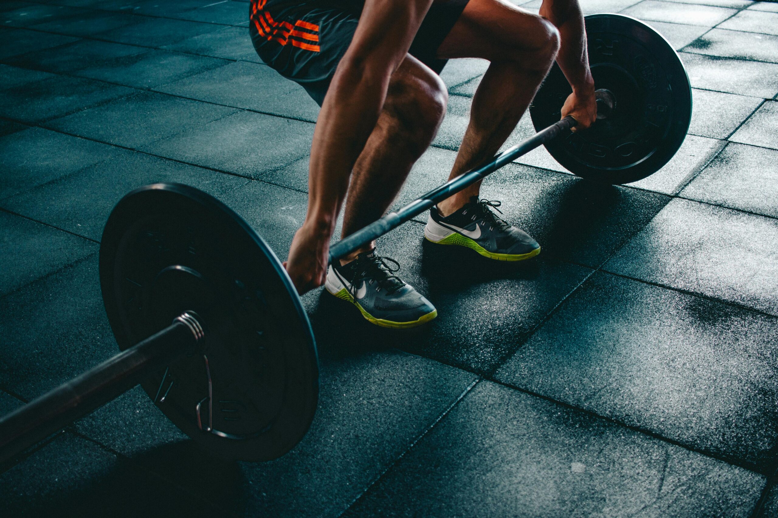 Man lifting dumbbells during strength training session in a gym
